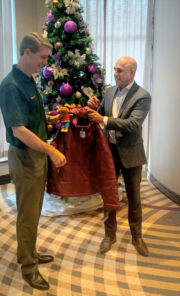 Senior Vice President of The 401 Auto RV Group of Companies, Jazz Mamak, presented the coats to State Deputy Marcel Lemmen